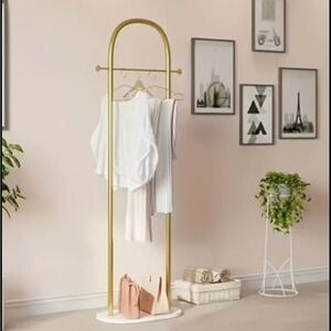 Stylish Gold Clothing Rack with White Apparel